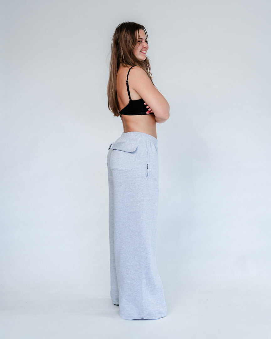 Vores Wide Leg Sweatpants kombinerer afslappet komfort med moderne design. Med et oversized fit falder bukserne flot og giver et casual look. Bukserne har baglommer med et subtilt embossed logo, der tilføjer et eksklusivt touch. Bukserne har snøre i taljen for en justerbar pasform – og snørerne i anklerne giver dig mulighed for at style dem, som du vil: lad dem hænge løst for det klassiske wide leg-look, eller snør dem ind for et mere tapered udtryk.