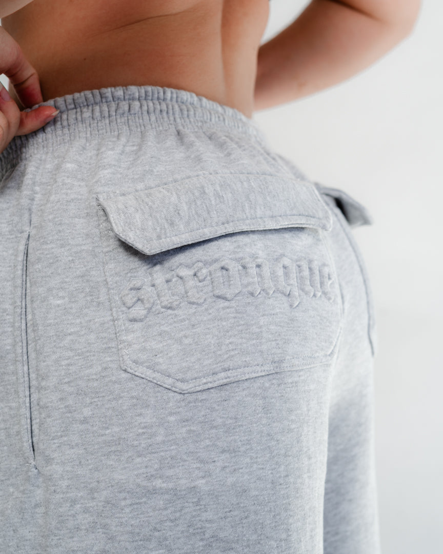 Vores Wide Leg Sweatpants kombinerer afslappet komfort med moderne design. Med et oversized fit falder bukserne flot og giver et casual look. Bukserne har baglommer med et subtilt embossed logo, der tilføjer et eksklusivt touch. Bukserne har snøre i taljen for en justerbar pasform – og snørerne i anklerne giver dig mulighed for at style dem, som du vil: lad dem hænge løst for det klassiske wide leg-look, eller snør dem ind for et mere tapered udtryk.